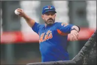  ?? The Associated Press ?? CALLAWAY CANNED: New York Mets manager Mickey Callaway throws batting practice before the team’s game against the Colorado Rockies on Sept. 17 in Denver. Callaway was fired by the Mets Thursday.