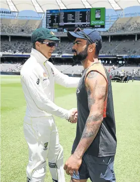  ?? Picture: RYAN PIERSE/GETTY IMAGES ?? FROSTY RELATIONS: Tim Paine, of Australia, shakes hands with Virat Kohli, of India, after Australia claimed victory during day five of the second match at Perth Stadium on Tuesday