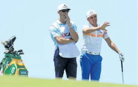  ?? RICHARD HEATHCOTE/GETTY IMAGES ?? Rickie Fowler of the United States, right, and caddie Joe Skovron prepare for a shot on the eighth hole during the first round of the 2017 U.S. Open at Erin Hills on Thursday in Hartford, Wis.