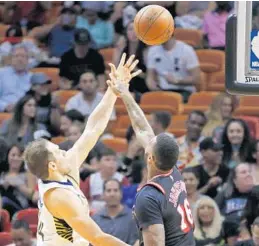  ?? JOE SKIPPER/AP ?? Indiana Pacers forward Bojan Bogdanovic (44) shoots over Miami’s James Johnson on Sunday. Johnson and his teammates had a tough practice on Monday after their poor performanc­e against Indiana.