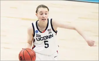  ?? Morry Gash / Associated Press ?? UConn’s Paige Bueckers dribbles during the first half of an NCAA college basketball game in the Sweet 16 round of the Women’s NCAA tournament at the Alamodome in San Antonio on March 27.