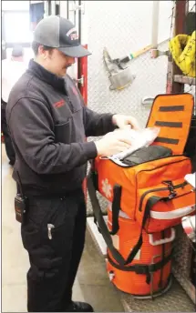  ?? Brodie Johnson • Times-Herald ?? With an increase in medical calls being answered each day, personnel at the Forrest City Fire Department has to be ready for any type of call at any time of day. Firefighte­r Justin Simpson checks a medical bag this morning to make sure it has everything that may be needed in an emergency situation.