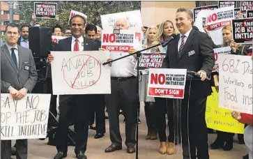  ?? Gabriel San Roman Los Angeles Times ?? TODD AMENT, the former head of the Anaheim Chamber of Commerce, shown at the lectern, has agreed to plead guilty in a corruption scandal. Ament was charged with lying to a mortgage lender, among other counts.