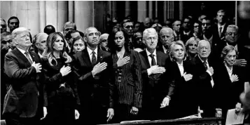  ?? ALEX BRANDON/AP ?? President Donald Trump, left, and first lady Melania Trump view the funeral Wednesday with former presidents and their wives — Barack Obama, Michelle Obama, Bill Clinton, Hillary Clinton, Jimmy Carter and Rosalynn Carter — in Washington.