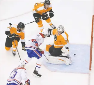  ?? DAN HAMILTON/USA TODAY SPORTS ?? Canadiens centre Jesperi Kotkaniemi scores on Flyers goaltender Carter Hart during Montreal’s 5-0 win on Friday. The young Finn now leads the Habs with four goals in six playoff games.