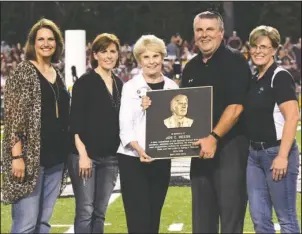  ?? The Sentinel-Record/Grace Brown ?? FAMILY AFFAIR: The family of former Hot Springs coach Joe Reese accepts a plaque on his behalf during halftime of Hot Springs football game against Lake Hamilton on Friday. Pictured, from left, are his daughter-in-law Sara Reese, daughter Angie Venable, widow Karen Reese, son Brad Reese and daughter Leigh Cobb.