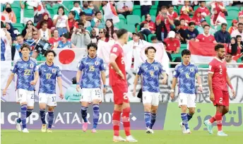  ?? — AFP photos ?? Japan’s Ayase Ueda (third right) walks with his teammates during the match against Indonesia.