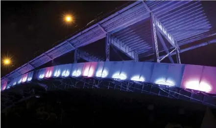  ??  ?? Anzac Parade Bridge lit in blue and pink lights to raise awareness of Huntington’s disease.