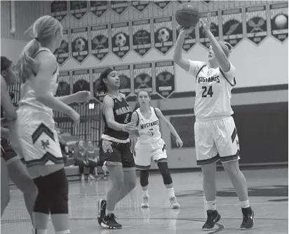  ?? DANIEL KUCIN JR./BALTIMORE SUN MEDIA GROUP ?? Marriotts Ridge’s Emma Miller shoots over several Oakland Mills defenders during the Mustangs’ victory Thursday night.