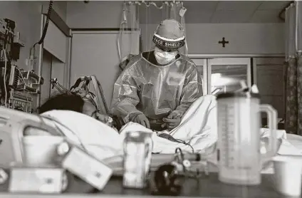  ?? Photos by Jae C. Hong / Associated Press ?? Registered nurse Merri Lynn Anderson tends to her patient in a COVID-19 unit at St. Joseph Hospital in Orange, Calif.