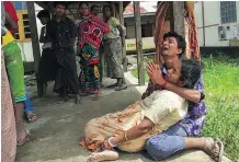  ?? — GETTY IMAGES ?? Hindus mourn for family members, whom they believe were killed by militants Sunday in Maungdaw, Myanmar, as clashes continued in the country’s west.