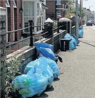 ??  ?? These blue rubbish bags on Maesteg Road in Tondu should have been collected on June 12