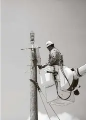  ?? Staff file photo ?? In this photo from 2019, Alex Alvarado installs an angle from a bucket truck at CPS Energy's training grounds in San Antonio.