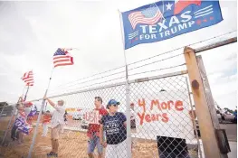  ?? BEN POWELL/ODESSA AMERICAN ?? Supporters of President Donald Trump display flags and signs as they wait for Air Force One to land Wednesday in Midland, Texas.