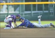  ?? Peter Aiken/Getty Images ?? LSU second baseman Cole Freeman tags out Florida’s Dalton Guthrie on a steal attempt in the first inning.