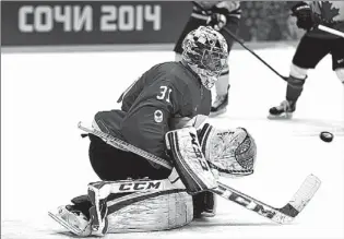  ??  ?? n Canada goaltender Carey Price blocks a shot by Sweden during the third period of the men’s gold medal ice hockey game Sunday at the 2014 Winter Olympics in Sochi, Russia. Canada won, 3-0.