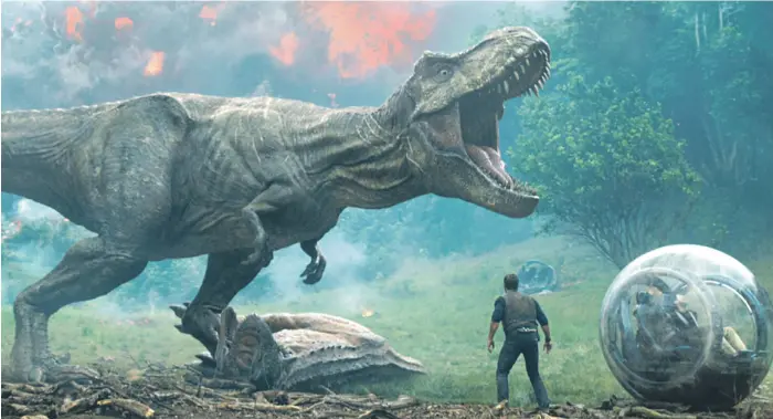  ?? Universal ?? ‘Jurassic World: Fallen Kingdom’ is the second of three films that have revived writer Michael Crichton’s theme-park-gone-wrong series and sent actor Chris Pratt’s stock soaring