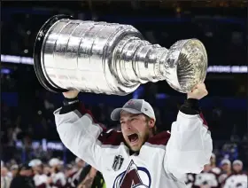  ?? Andy Cross / The Denver Post ?? Colorado Avalanche goaltender Darcy Kuemper (35) hoists the Stanley Cup after defeating the Tampa Bay Lighting at Amalie Arena June 26.