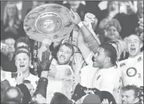  ??  ?? England’s captain Chris Robshaw (center), raises the Hillary Shield following victory in the internatio­nal rugby union match against New Zealand at Twickenham Stadium, southwest of London, on Dec 1. England ended world champions New Zealand’s 20-match...