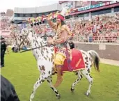  ?? STEPHEN M. DOWELL/ORLANDO SENTINEL ?? In a Florida State University football tradition since 1978,“Chief Osceola” rides an Appaloosa horse named Renegade during a game at Tallahasse­e’s Doak Campbell Stadium in 2013.