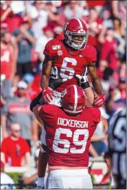  ?? AP/VASHA HUNT ?? Alabama offensive lineman Landon Dickerson (69) lifts Alabama wide receiver DeVonta Smith (6) to celebrate Smith’s touchdown against Mississipp­i during the first half Saturday in Tuscaloosa, Ala.