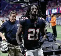  ?? JOHN BAZEMORE / ASSOCIATED PRESS ?? Falcons cornerback Desmond Trufant leaves the field after sustaining a concussion last week against Tampa Bay. He missed Sunday’s loss to Minnesota.