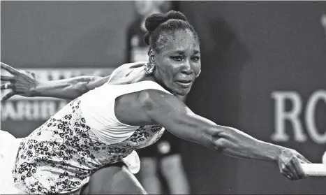  ?? (AP PHOTO/CRYSTAL CHATHAM) ?? RETURN. Venus Williams, 37, stretches to return a shot to opponent and sister Serena Williams during the third round of the BNP Paribas Open tennis tournament at the Indian Wells Tennis Garden in Indian Wells, Calif., Monday, March 12, 2018.