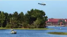  ?? RED HUBER/TRIBUNE NEWS SERVICE ?? Florida Fish and Wildlife and an Orange County sheriff’s helicopter searched for a boy early Wednesday after he was snatched by an alligator.