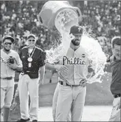  ?? Matt Marton Associated Press ?? COLE HAMELS IS DOUSED after throwing the first no-hitter against the Cubs in 50 years.