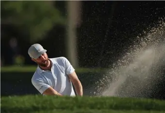  ??  ?? SAND STORM: Chris Kirk plays a shot from a bunker on the 17th hole during the third round of the Rocket Mortgage Classic on Saturday.