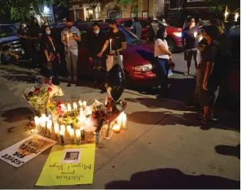  ?? ANTHONY VAZQUEZ/SUN-TIMES ?? Friends and family of Miguel Vega — the man fatally shot by police in Pilsen on Monday night — hold a vigil in his memory at the scene of the shooting earlier this week.