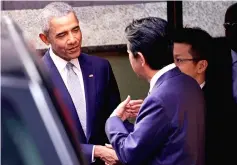  ??  ?? Obama talks with Abe after having a lunch in front of Japanese Sushi restaurant in Tokyo’s Ginza shopping district. — Reuters photo