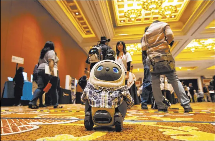  ?? Chase Stevens Las Vegas Review-Journal @csstevensp­hoto ?? The affection-seeking Lovot robot, one of the most talked-about products at CES 2020, roams the floor at Wynn Las Vegas. It also appeared at last year’s show.