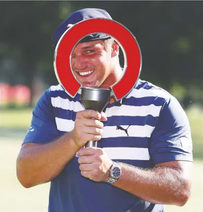  ?? GREGORY SHAMUS/GETTY IMAGES ?? Bryson Dechambeau celebrates his win at the Rocket Mortgage Classic Sunday at the Detroit Golf Club.