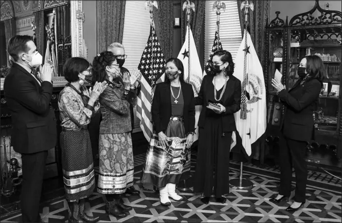  ?? KENNY HOLSTON / NEW YORK TIMES FILE ?? Deb Haaland, center, is sworn in as the secretary of the interior by Vice President Kamala Harris, right, on March 18 at the White House. In one of her first moves, Haaland streamline­d the process for Native American tribes to reacquire public lands from the federal government.