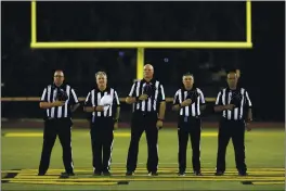  ?? ANDA CHU — BAY AREA NEWS GROUP, FILE ?? Football officials stand during the playing of the National Anthem before a 2019 game between Moreau Catholic and James Logan in Hayward.