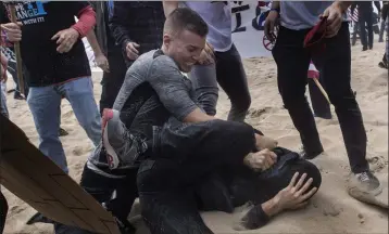  ?? MINDY SCHAUER — STAFF PHOTOGRAPH­ER ?? Robert Paul Rundo holds down and punches a counterpro­tester at a political rally at Bolsa Chica State Beach in Huntington Beach on March 25, 2017, according to federal authoritie­s.