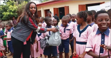  ??  ?? The Brand, Event and CSR Manager, Ikeja Electric PLC, Mrs. Titi Aikhomu, presenting gifts to pupils of Ilupeju Primary School, Lagos, during the Children’s Day celebratio­n it organised…recently