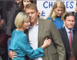  ?? Tyler Sizemore / Hearst Connecticu­t Media ?? Darien resident Scott Hapgood hugs his wife, Kallie Hapgood, at Town Hall in Darien on Oct. 28, 2019 as U.S. Sen. Richard Blumenthal, D-Conn., and the town show support for him in his manslaught­er charge.