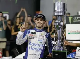  ?? ASSOCIATED PRESS ?? KYLE LARSON POSES with the trophy after winning the NASCAR All-Star Race at Charlotte Motor Speedway in Concord, N.C., Saturday.