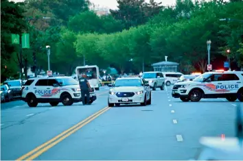  ?? — AFP ?? Police cars block the entrance to Pennsylvan­ia Avenue near the White House shortly after Secret Service guards shot a person who was apparently armed, outside the White House on Monday while US President Donald Trump was speaking to the press in the Brady Briefing Room of the White House in Washington, DC.