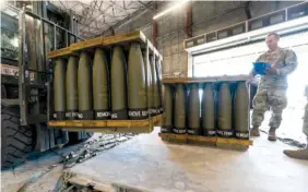  ?? AP PHOTOS/ALEX BRANDON ?? On Friday, U.S. Air Force Staff Sgt. Cody Brown with the 436th Aerial Port Squadron, checks pallets of 155 mm shells ultimately bound for Ukraine at Dover Air Force Base, Del.