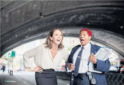  ??  ?? Diane Lane laughs it up with Carol Torres, a traffic captain who recognised her, under the Manhattan end of the Queensboro Bridge, in New York.