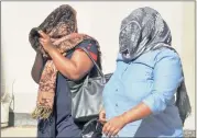  ?? Picture:BHEKI RADEBE ?? JAILED: Dideka Tosha and Thumeka Nguqe, covering their faces, were among former Sassa officials sentenced to seven years in prison.