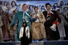  ?? NATACHA PISARENKO — THE ASSOCIATED PRESS ?? Claudia Poblete poses for a photo in front of a mural depicting the Mothers of Plaza de Mayo group, at the former Navy School of Mechanics, known as ESMA, now a human rights museum, in Buenos Aires, Argentina, on March 22.