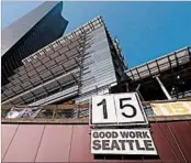  ?? TED S. WARREN/AP 2014 ?? Seattle was one of the first U.S. cities to adopt a $15 minimum wage, and its experience is being closely watched.