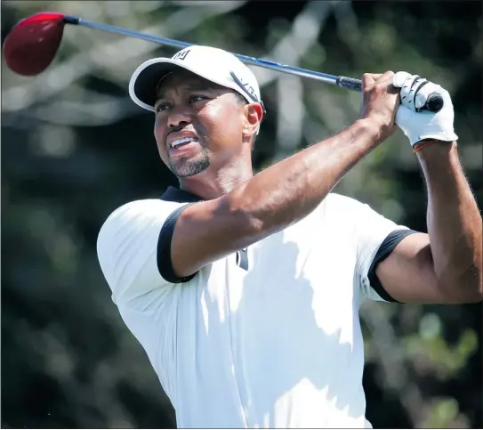  ?? — GETTY IMAGES ?? Tiger Woods plays a shot during the pro-am round for the Honda Classic at PGA National Resort and Spa on Wednesday in Palm Beach Gardens, Fla. Seven of the top 10 players from the world ranking are in this weekend’s field.
