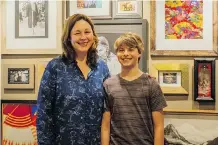  ?? COURTNEY LOVGREN ?? Jessica Waite and son Dash stand in front of a tribute wall dedicated to their late husband and father. Jessica Waite created a website to help other widows share tales of their late loved ones.