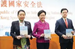  ?? CALVIN NG / CHINA DAILY ?? Hong Kong Chief Executive Carrie Lam Cheng Yuet-ngor (center), Secretary for Justice Teresa Cheng Yeuk-wah, and Secretary for Security John Lee Ka-chiu attend a press conference, where Lam explained the national security law to the public on Wednesday.