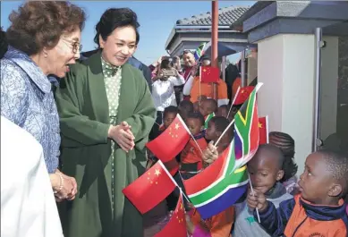  ?? WANG YE / XINHUA ?? Peng Liyuan, the wife of President Xi Jinping and a UNESCO special envoy, and South African first lady Tshepo Motsepe visit Uthando Day Care Preschool in a suburb of Pretoria, South Africa, on Tuesday.